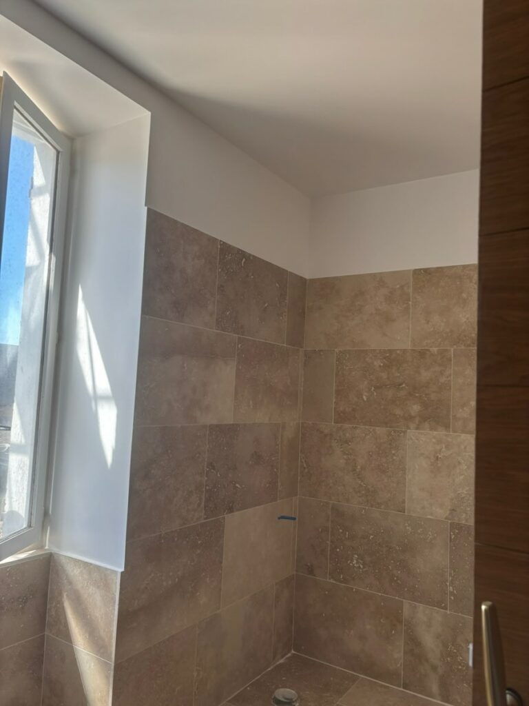 Salle de bain en travertin côté fenêtre à Malesherbes